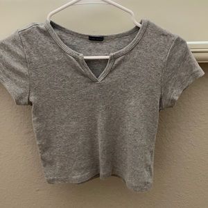 gray top with a slit in the neck line